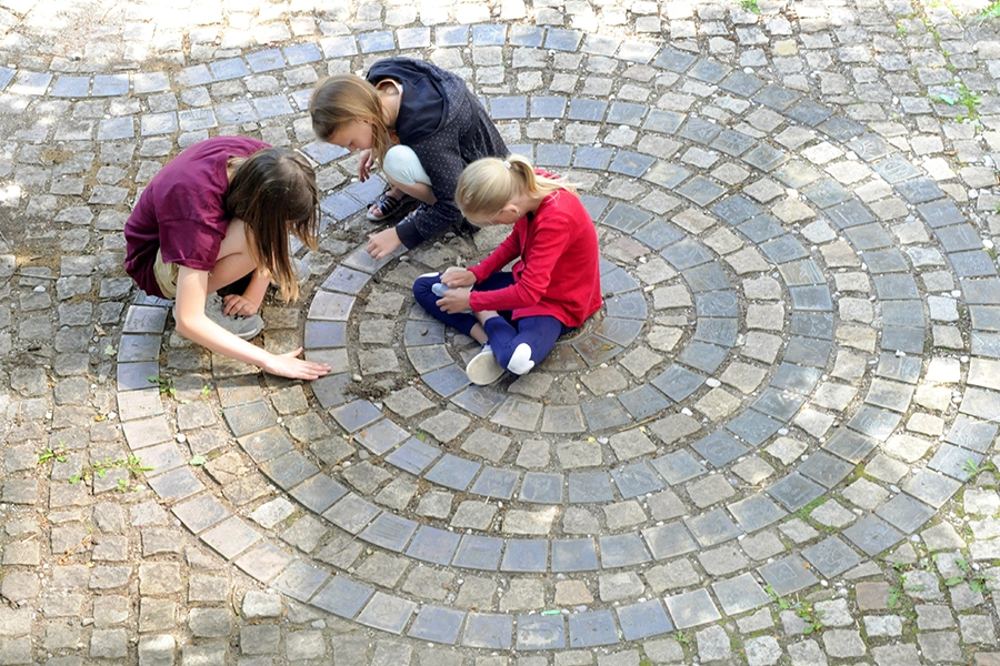Schüler der Montessori Schule Peißenberg spielen auf der Schulspiale im Pausenhof